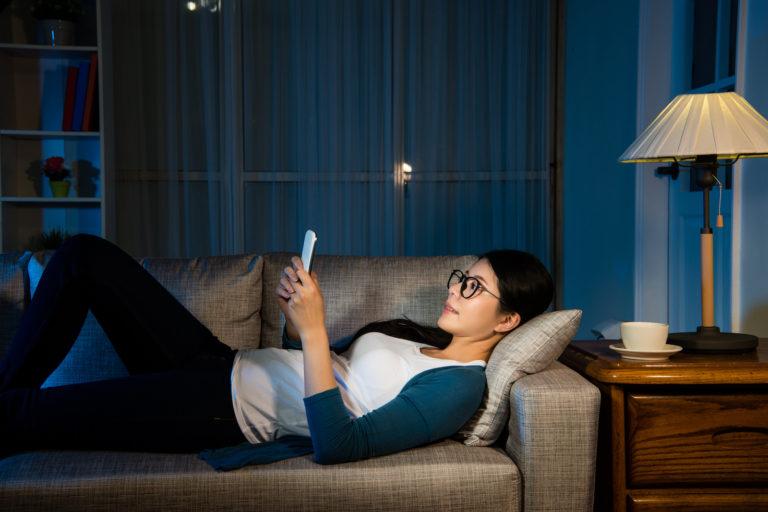 Woman using phone to chat with AI Member Assistant